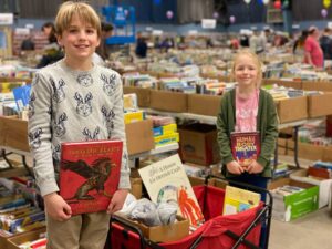 two children and a Cart of books