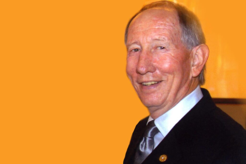 Lee B. Brawner headshot on yellow background