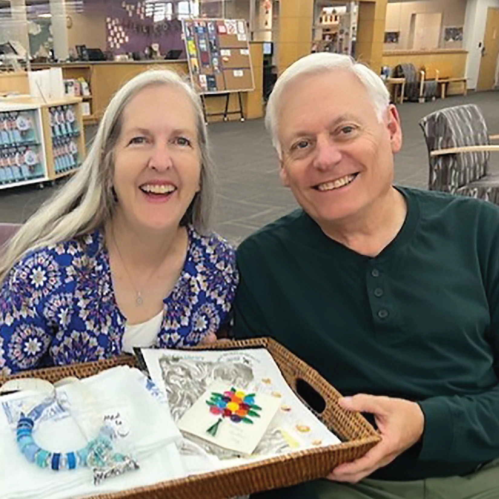 Kathy and Drew M, two Friends of the Library members sharing crafts they've made